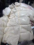 White long puffer jacket with hood, quilted baffles, and visible zipper pocket