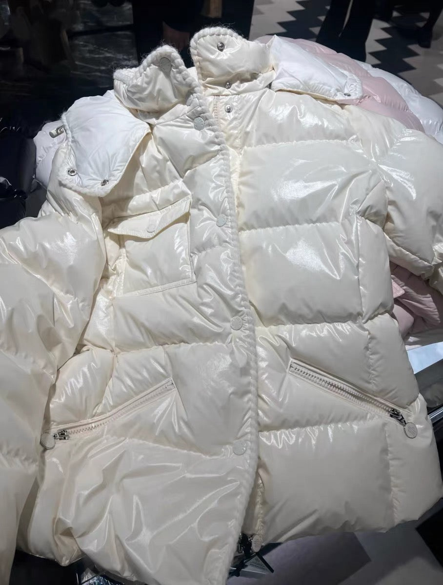 White long puffer jacket with hood, quilted baffles, and visible zipper pocket