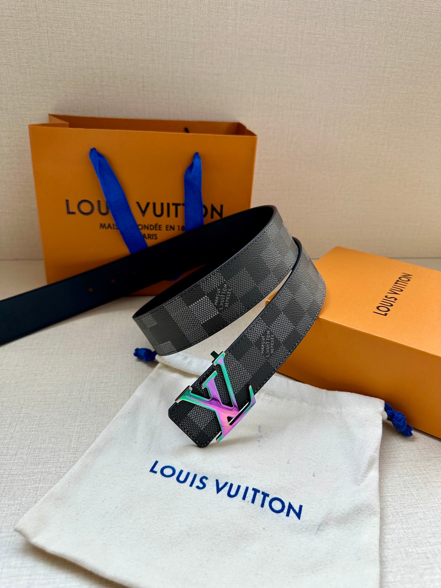 Gray checkered belt with multicolor LV buckle and folded strap end