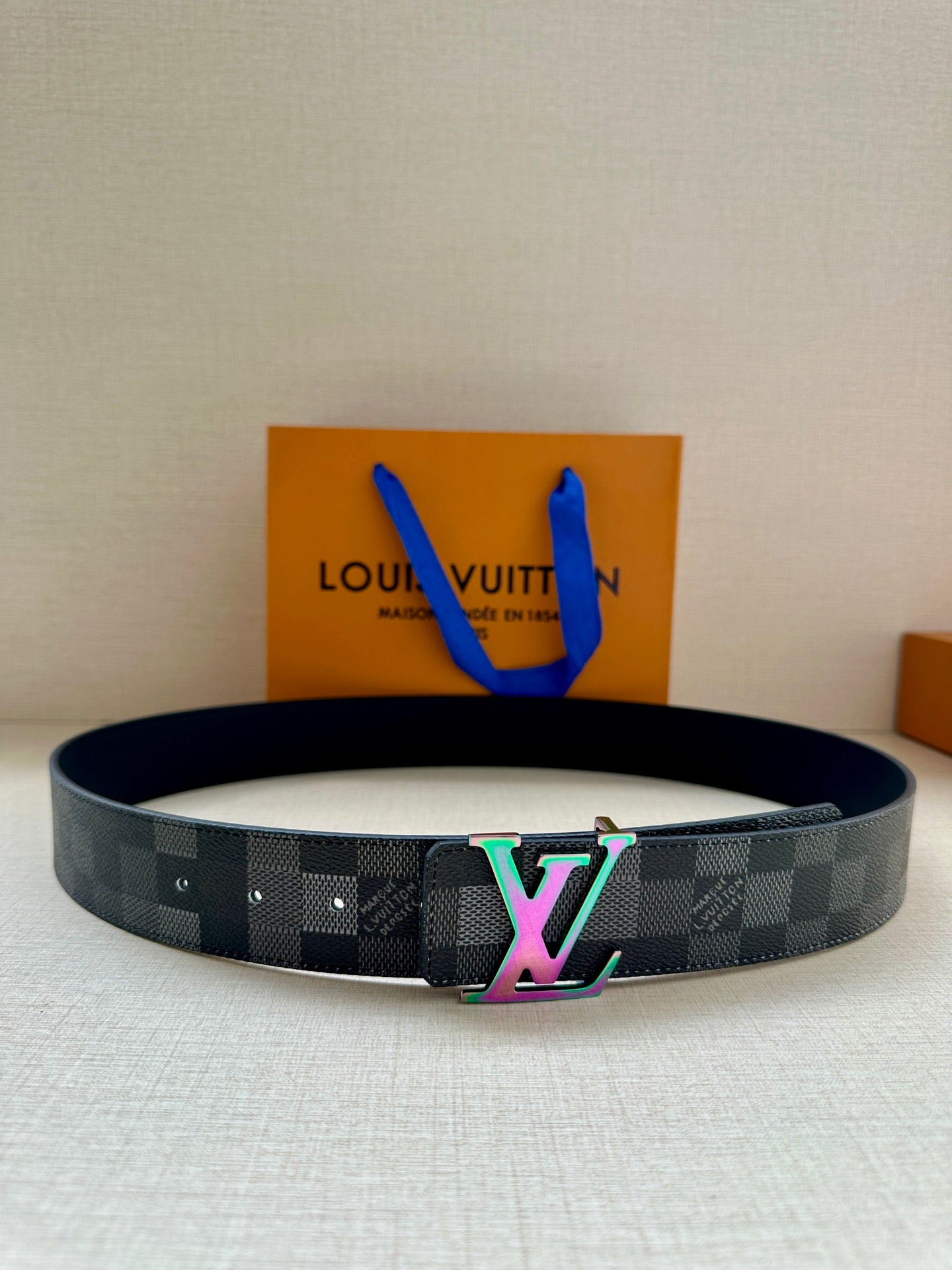 Dark checkered belt with multicolor LV logo buckle on strap