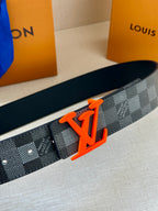 Louis Vuitton belt close-up with dark check pattern and orange LV buckle