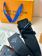 Louis Vuitton belt with dark monogram strap and black rectangular buckle