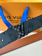Louis Vuitton belt detail: dark navy monogram strap with silver buckle and keeper