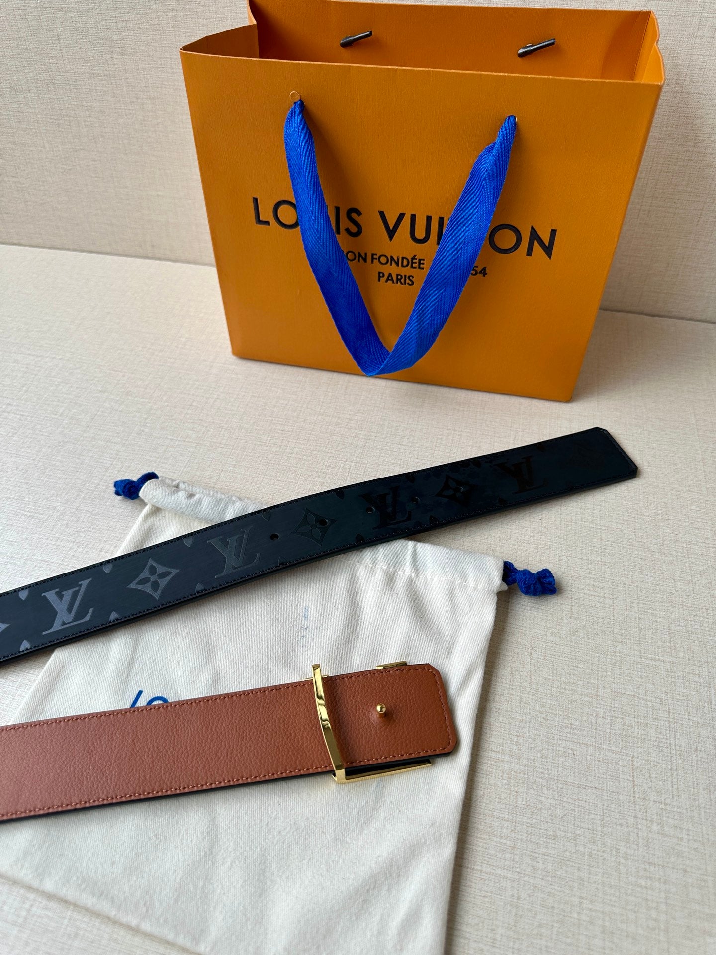 Louis Vuitton belt with tan leather strap and small square gold buckle, single keeper