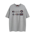 Grey short-sleeve T-shirt with Gucci logo graphics across the chest