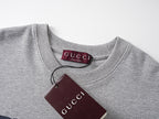 Grey crewneck T-shirt collar with Gucci interior label and maroon hang tag