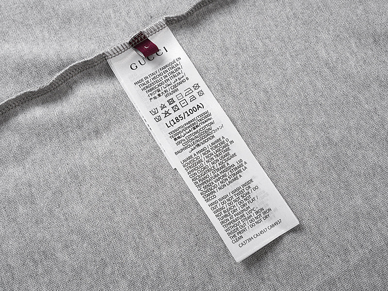 Grey T-shirt with white care label at the side seam