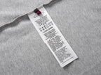 Grey T-shirt with white care label at the side seam