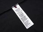 Black T-shirt with white care label tag on inner side seam