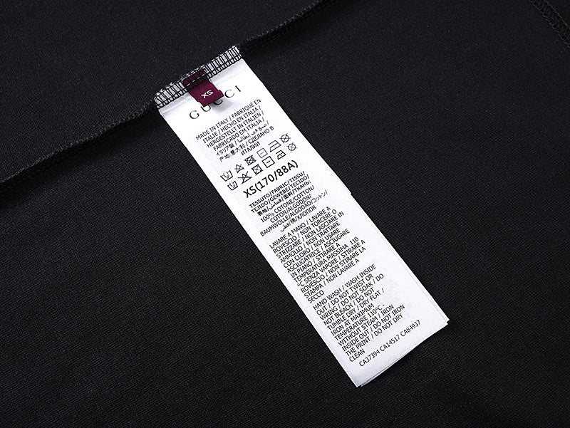 Black T-shirt with white care label tag on inner side seam