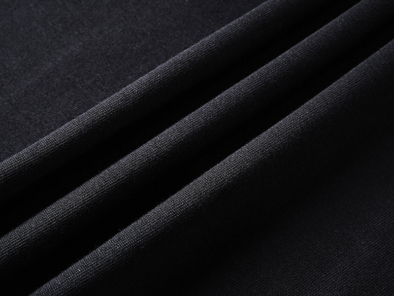 Black T-shirt fabric close-up showing woven texture