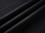 Black T-shirt fabric close-up showing woven texture