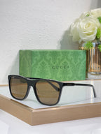 Gucci sunglasses with black frame and warm brown lenses