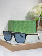 Gucci sunglasses with dark blue lenses and black frame