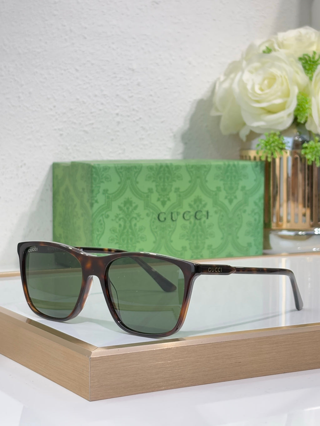 Gucci sunglasses with dark tortoiseshell frame and green-tinted lenses
