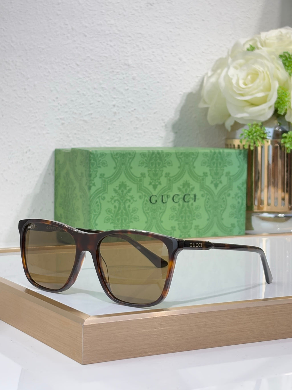Gucci sunglasses with dark tortoiseshell frame and brown gradient lenses