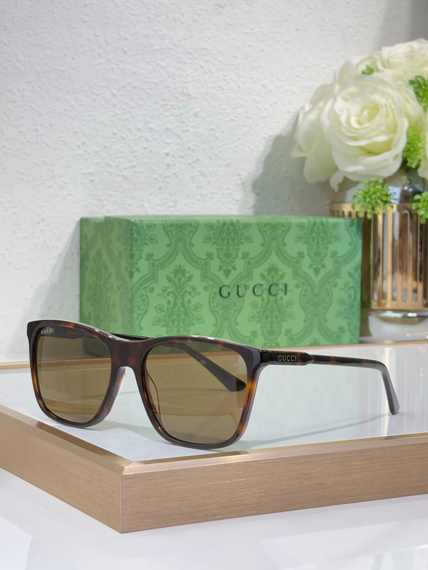 Gucci sunglasses with dark tortoiseshell frame and brown gradient lenses