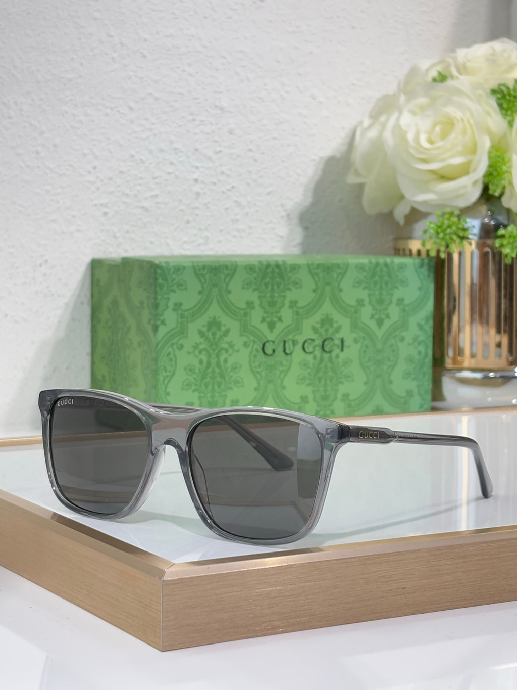 Gucci sunglasses with gray frame and smoke-tinted lenses