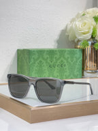 Gucci sunglasses with gray frame and smoke-tinted lenses