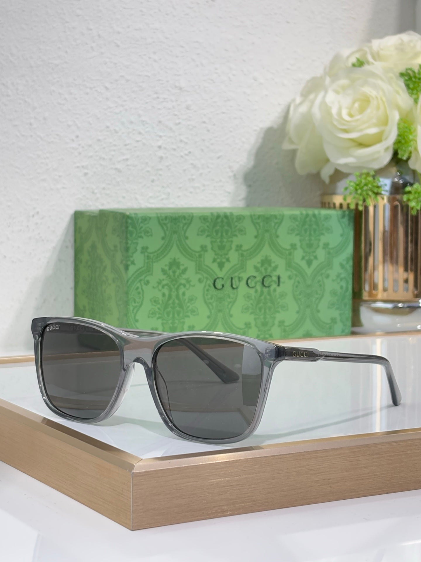 Gucci sunglasses with gray frame and smoke-tinted lenses