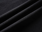 Black T-shirt fabric close-up with fine weave texture