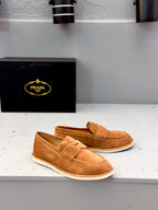 Tan suede slip-on loafers with double straps and stitched detail