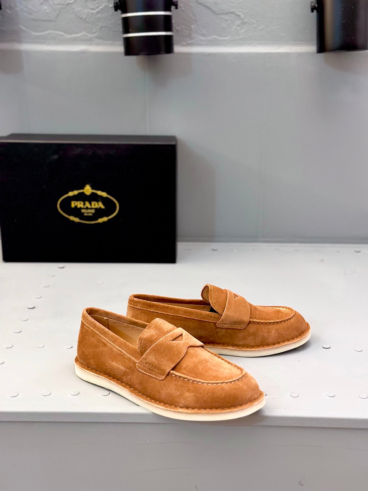 Tan suede slip-on loafers with double straps and stitched detail