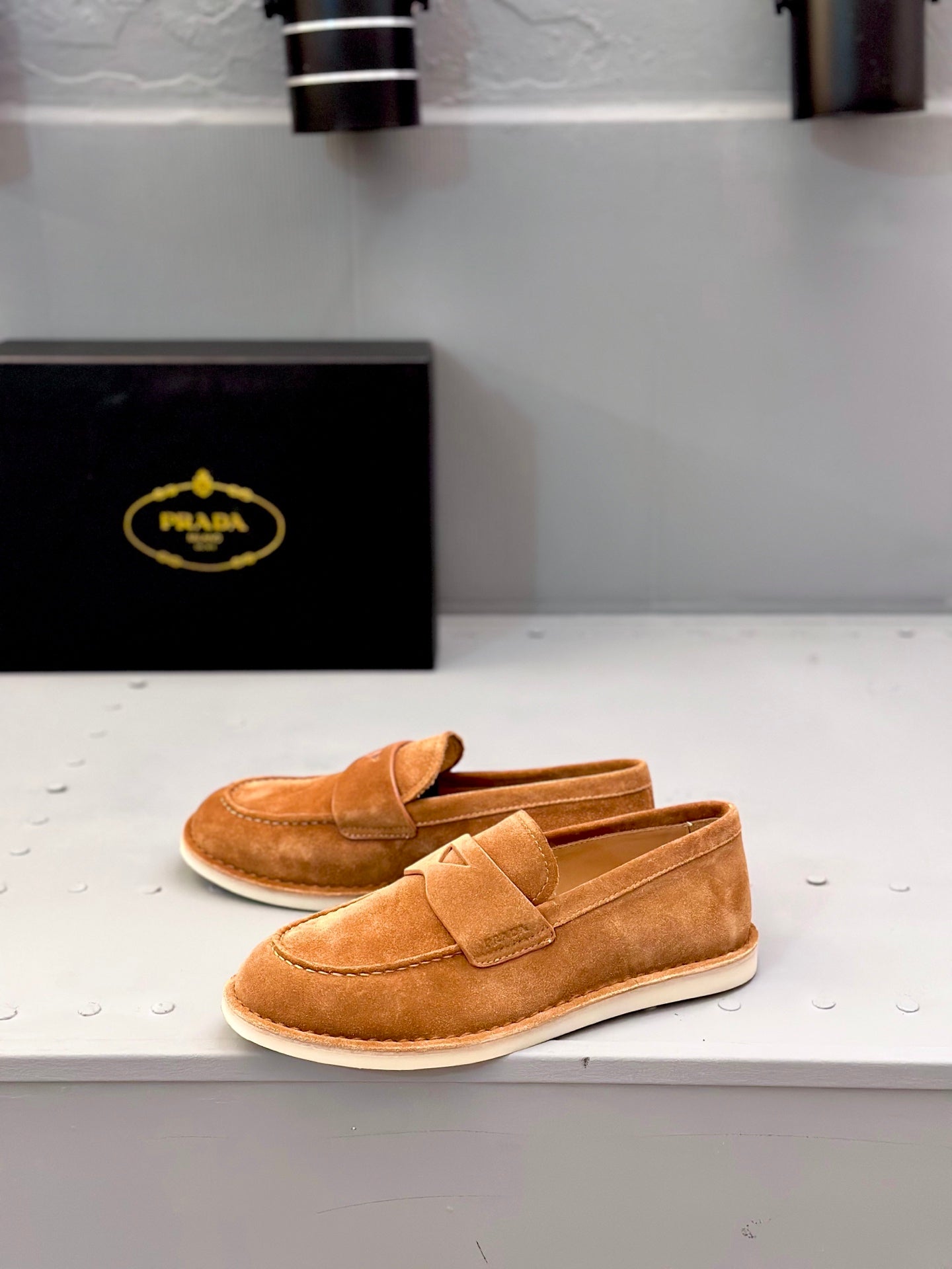 Tan suede loafers with strap vamp and white rubber sole edge