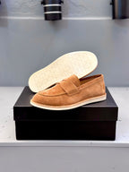 Tan suede loafer showing underside with textured rubber sole