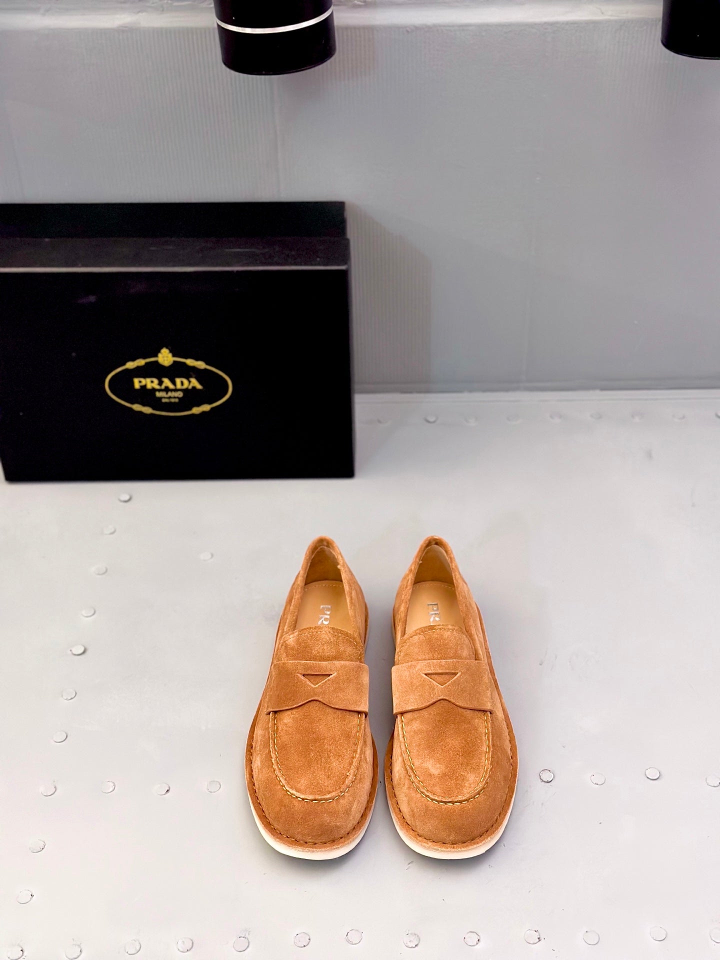 Tan suede loafers with strap and triangular stitching, slip-on style