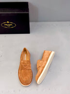 Tan suede loafers with strap vamp and Prada logo on insole