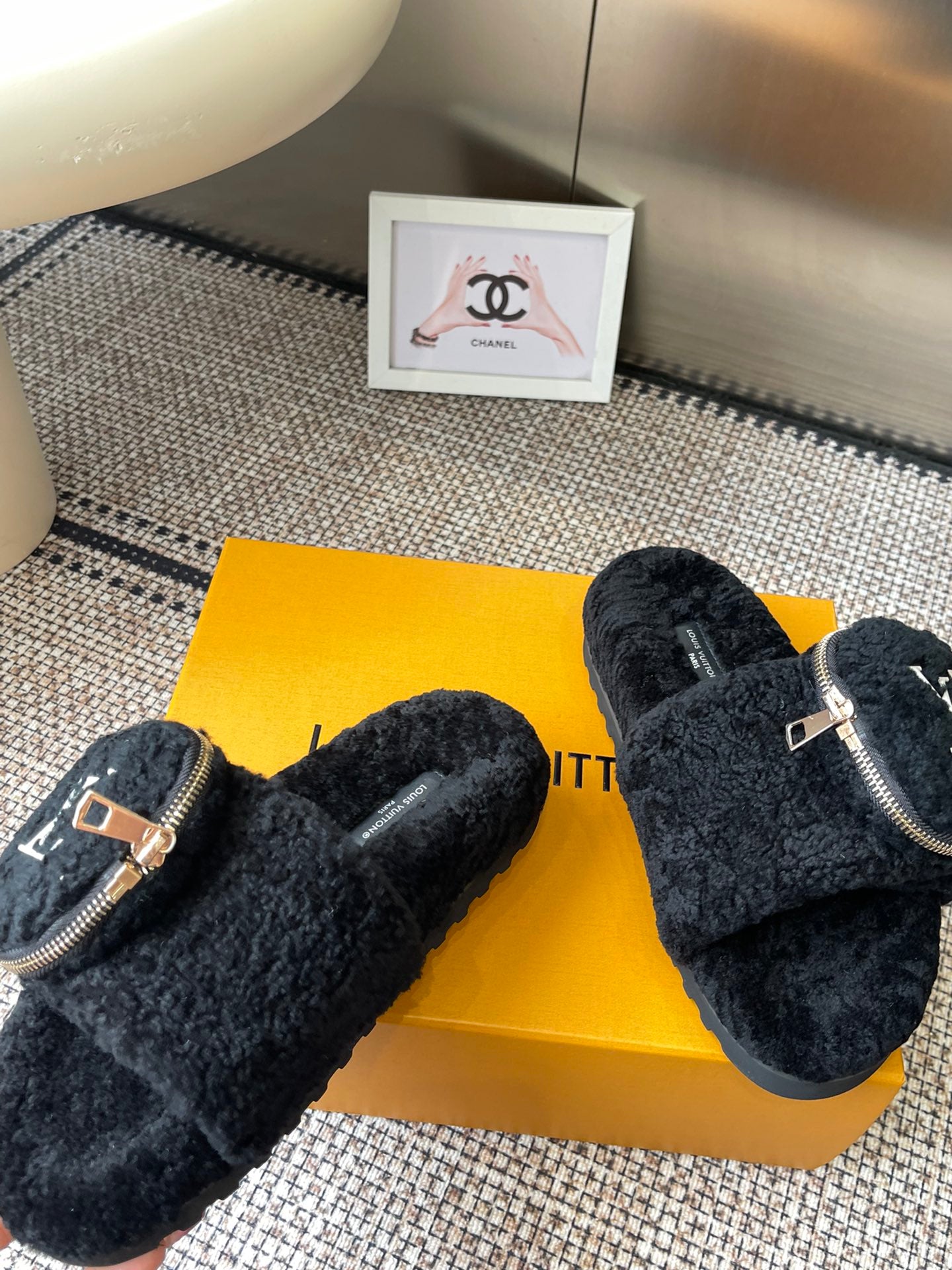 Louis Vuitton unisex black fuzzy slides with zipper strap and logo medallion