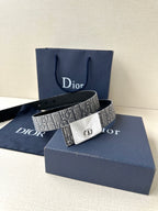 Dior belt with gray monogram strap and white/silver-toned buckle in front view