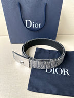 Dior belt with gray monogram strap, black edge trim, and gold-tone buckle