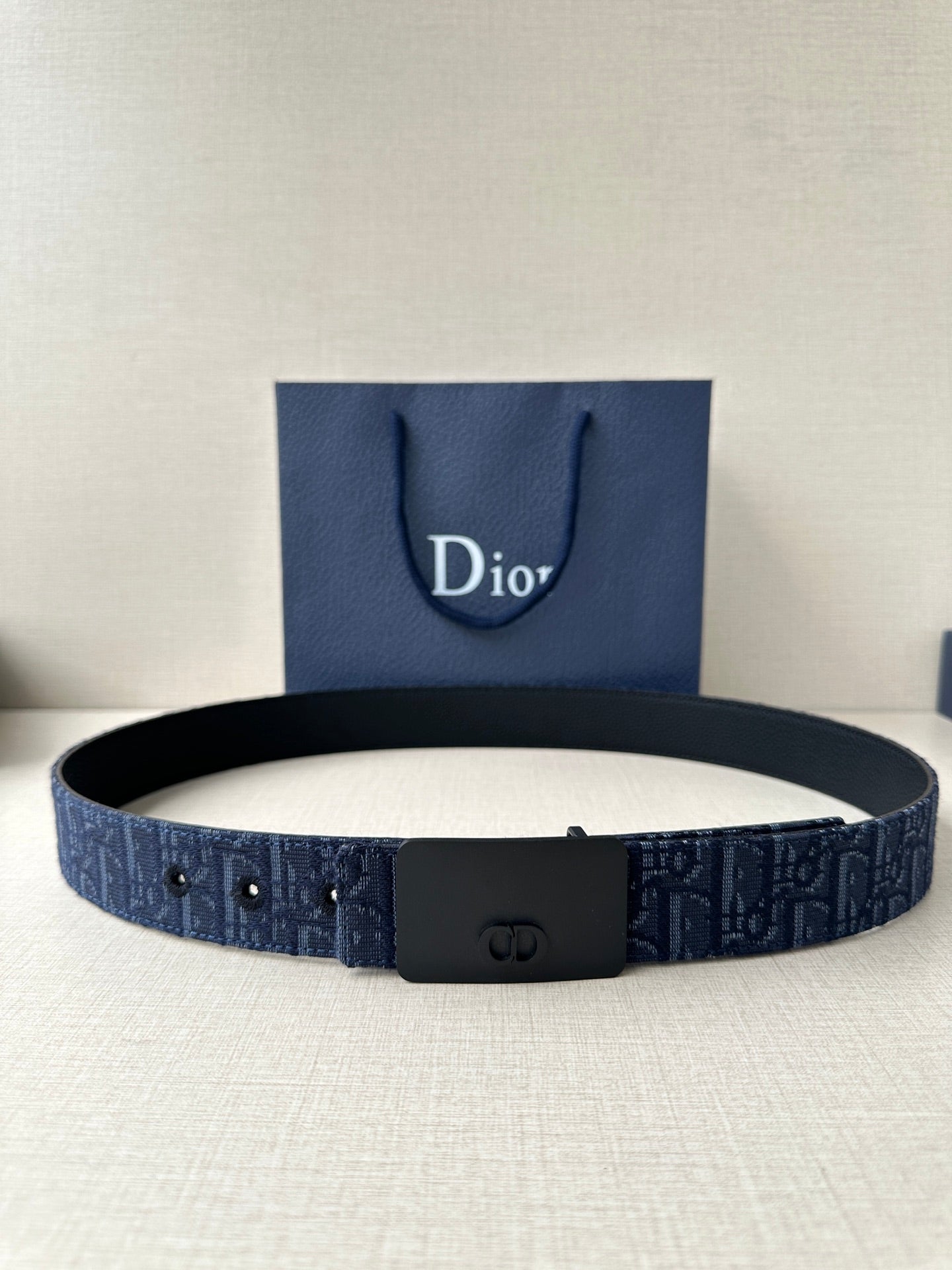 Dior belt in navy with black buckle, logo-pattern strap and multiple holes