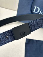 Dior belt close-up: dark buckle on navy logo-pattern strap with eyelets