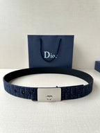 Dior belt in navy blue with dark pattern, silver-tone rectangular buckle, holes on strap.