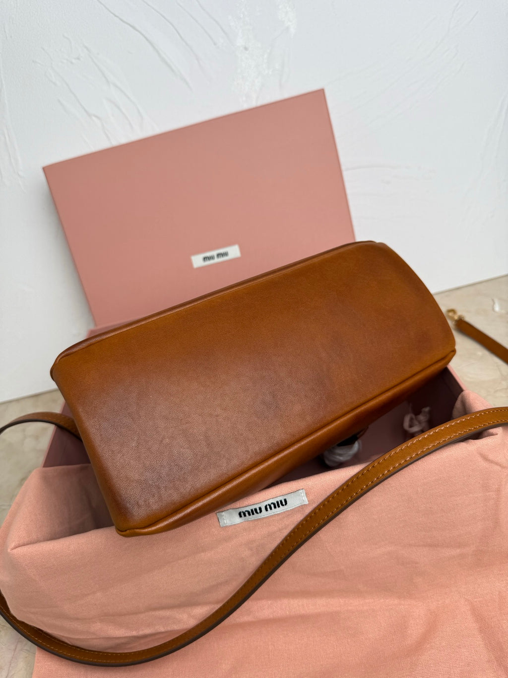 Brown MiuMiu crossbody bag with flap and long leather shoulder strap
