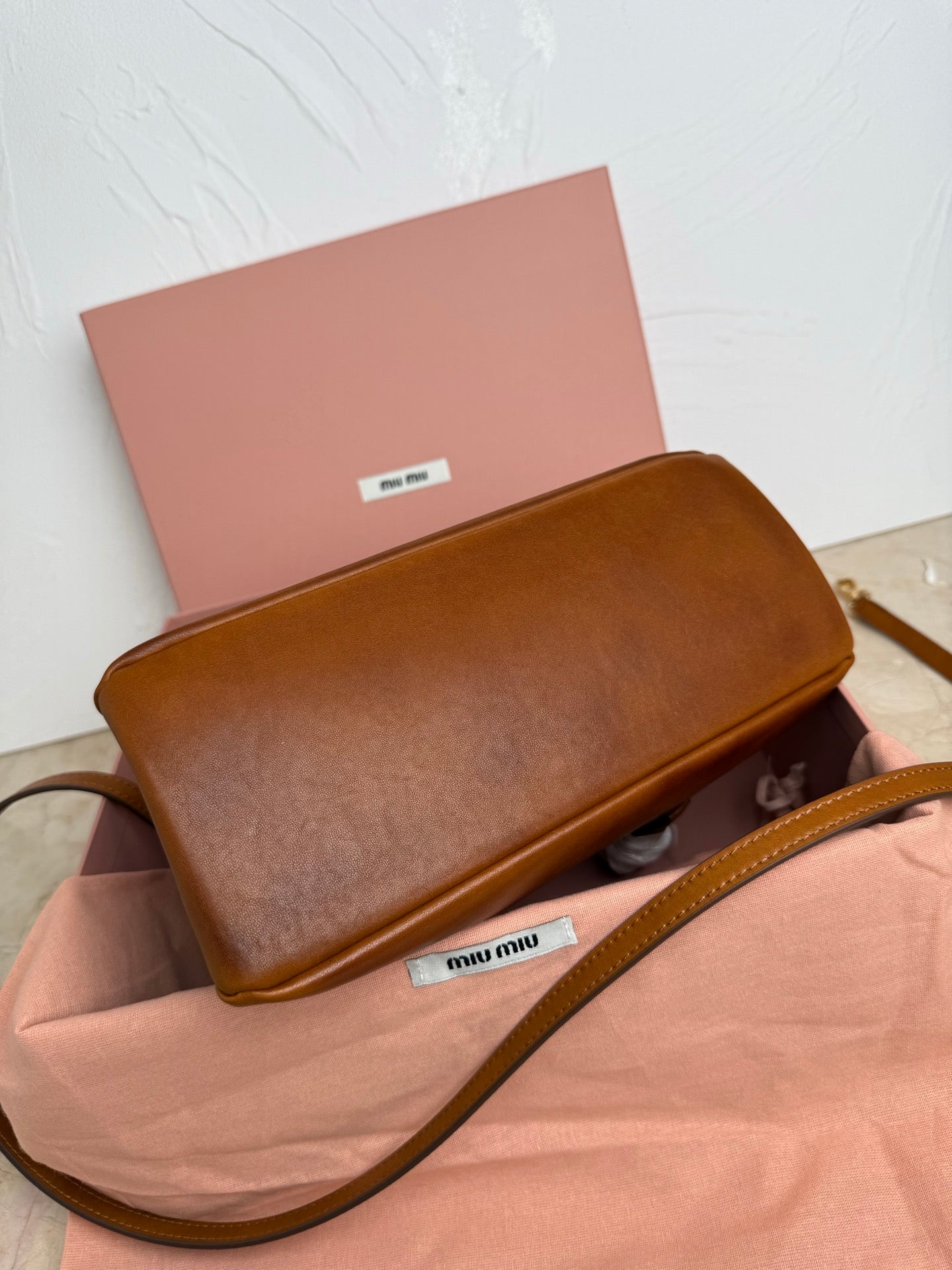 Brown MiuMiu crossbody bag with flap and long leather shoulder strap