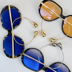 Sunglasses with blue lenses and gold and tortoiseshell frames