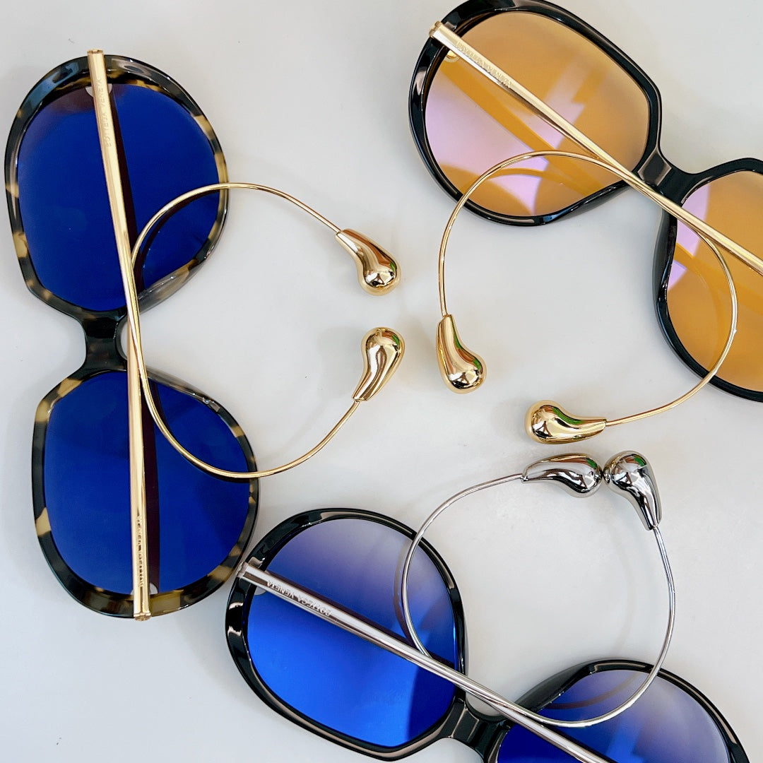 Sunglasses with blue lenses and gold and tortoiseshell frames