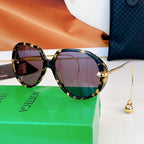 Sunglasses with tortoiseshell frames and amber-tinted lenses, gold arms