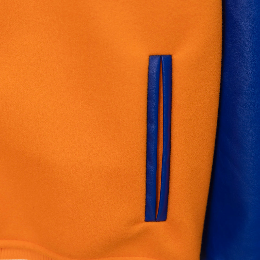 Orange varsity jacket sleeve stripe panel with blue trim and curved edge detail