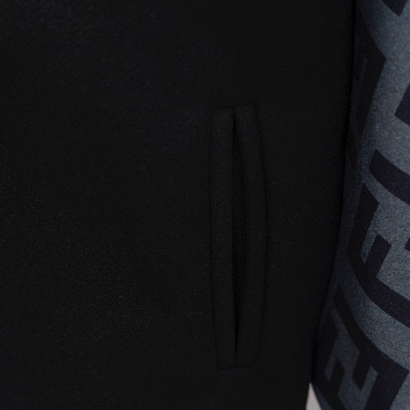 Black jacket front with button placket and subtle seam detailing
