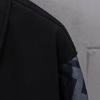 Black jacket sleeve with knit texture and FF logo stripe panel at cuff
