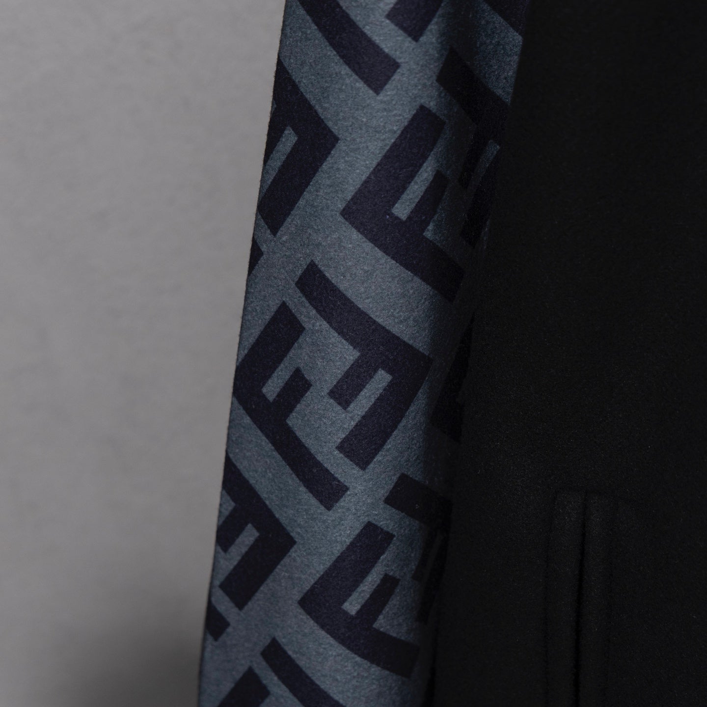 Black jacket sleeve detail with large FF logo pattern panel
