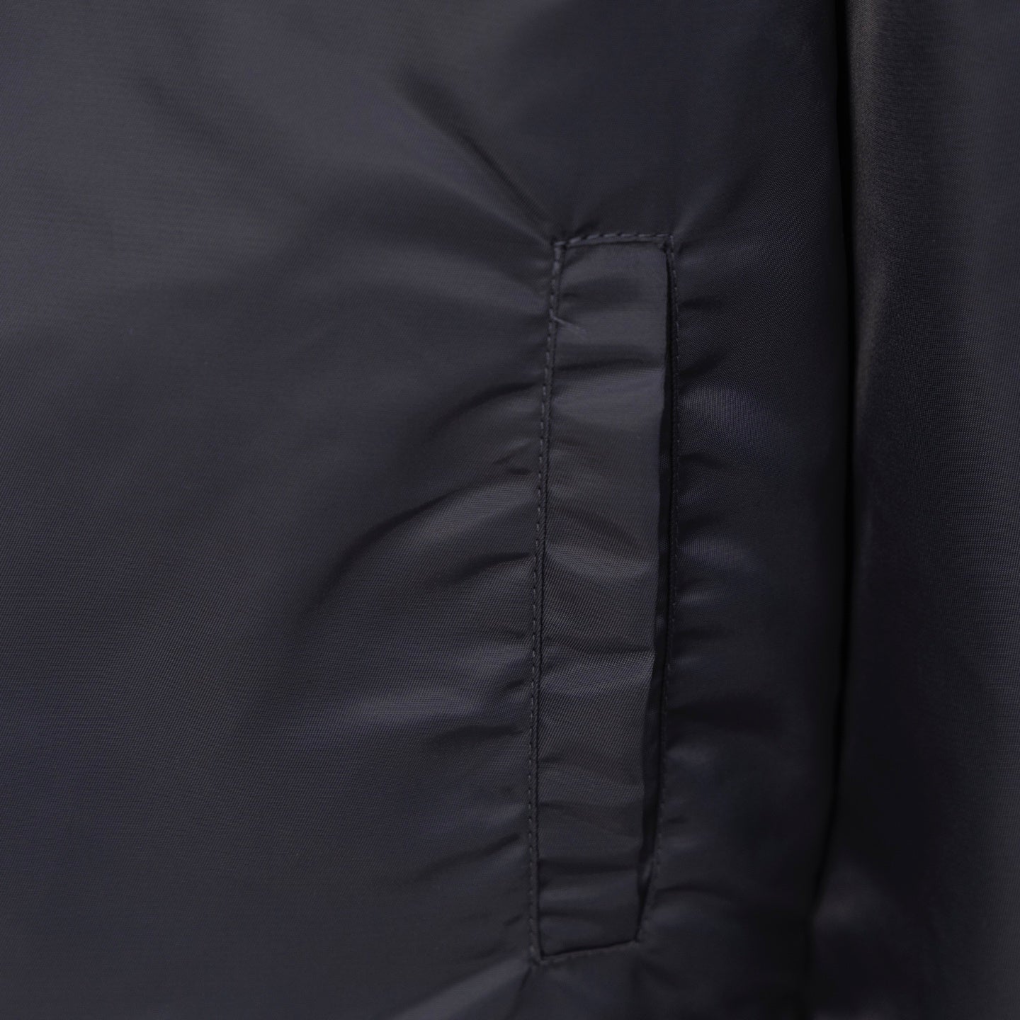 Louis Vuitton long bomber jacket front seam detail with dark snapped panel
