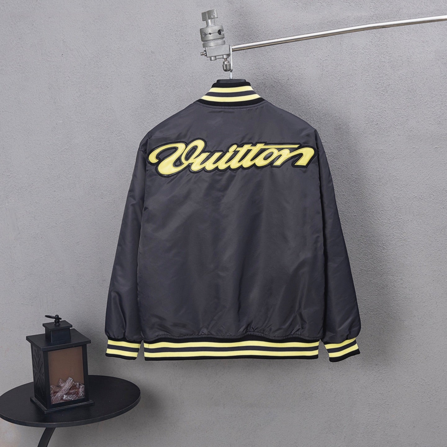 Louis Vuitton long bomber jacket, back view, yellow script logo and striped hem