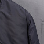 Louis Vuitton long bomber jacket sleeve with smooth dark fabric and stitching