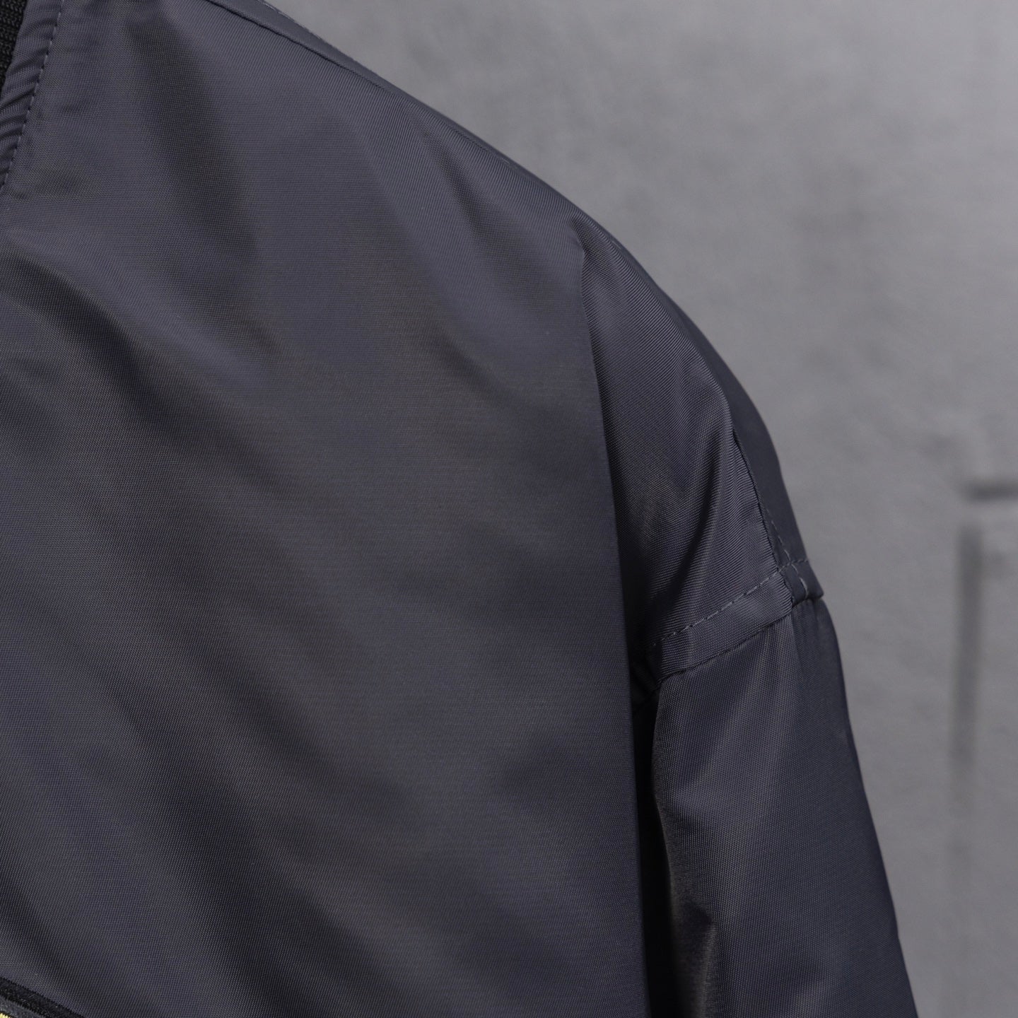 Louis Vuitton long bomber jacket sleeve with smooth dark fabric and stitching